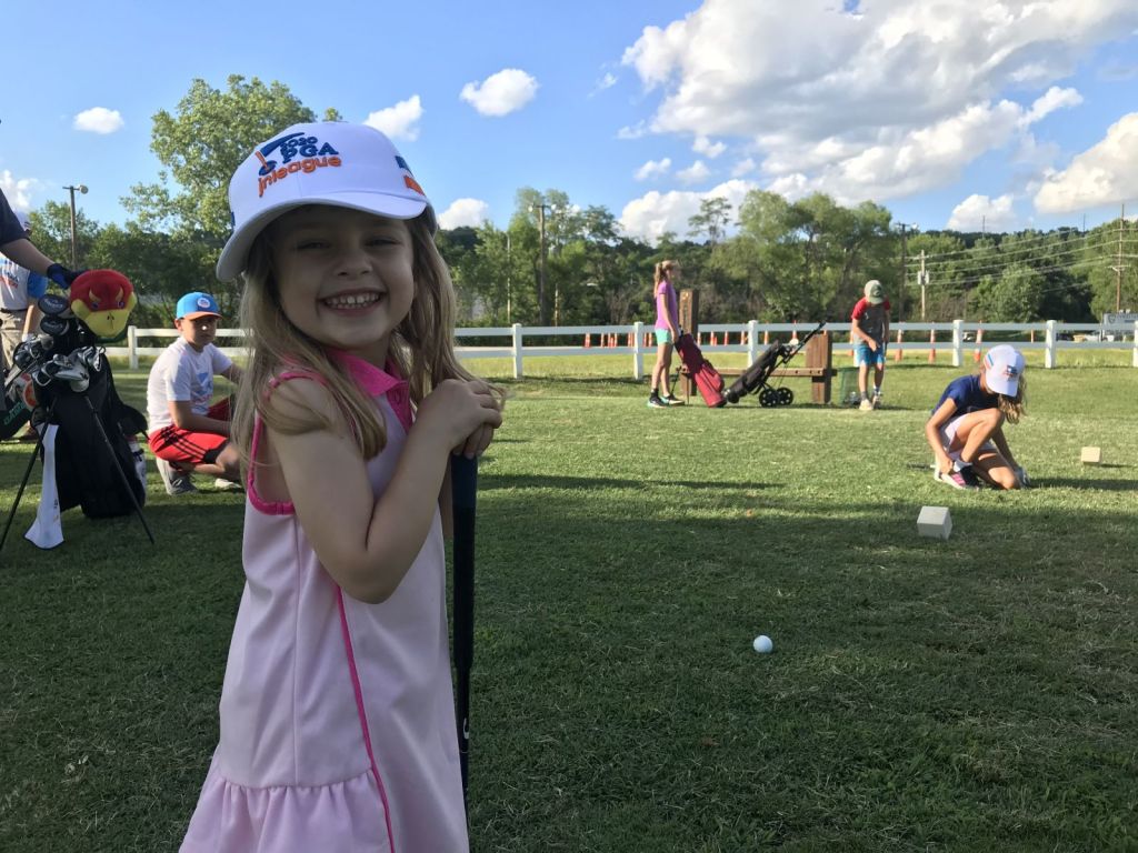 younger golfer smiling