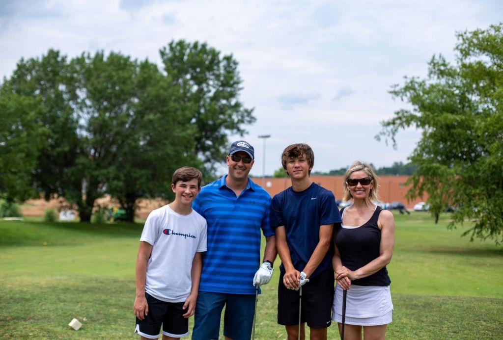 family posing for a picture on the course