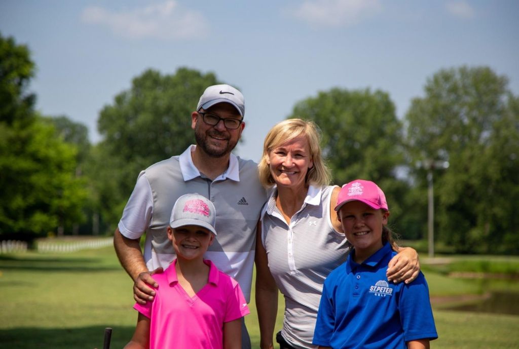 family posing for a picture on the course