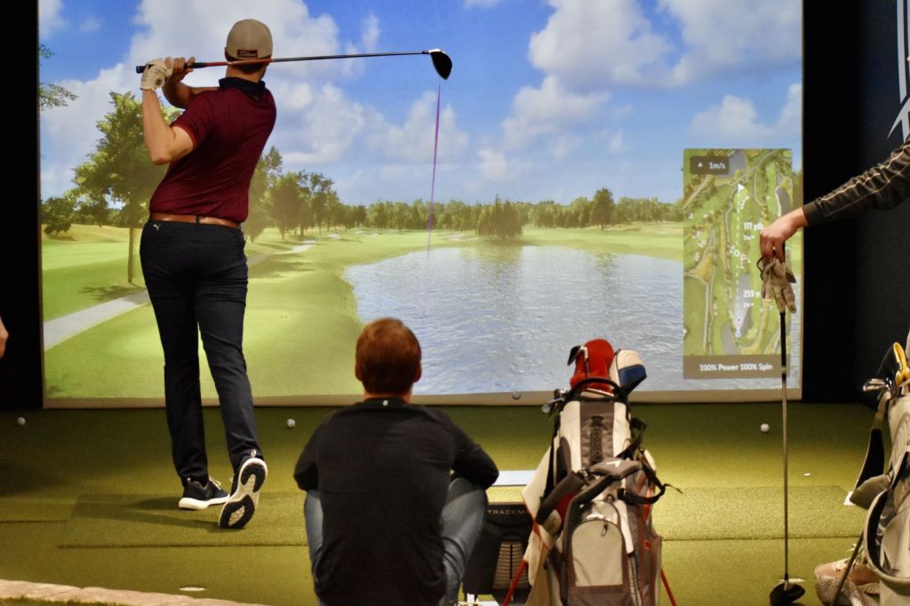 golfer taking a swing at the simulator