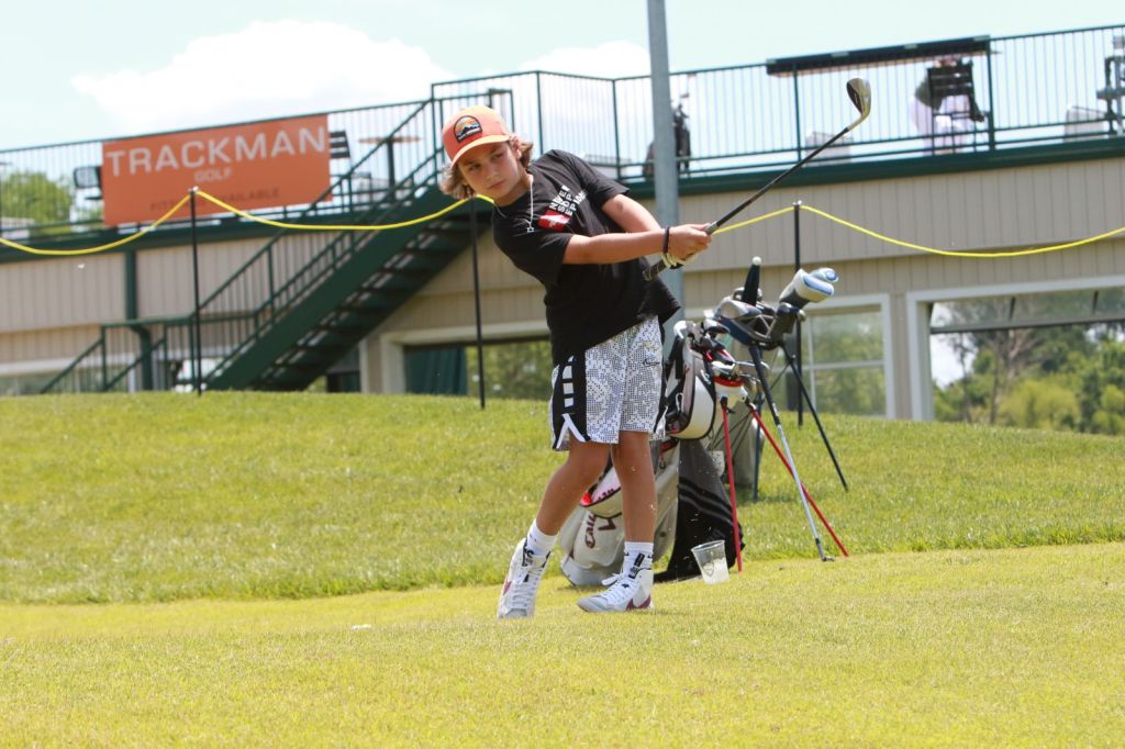 junior golfer swinging