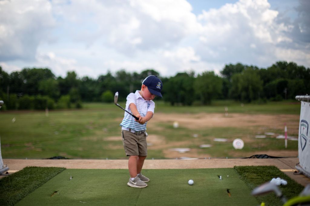 junior golfer at the driving range